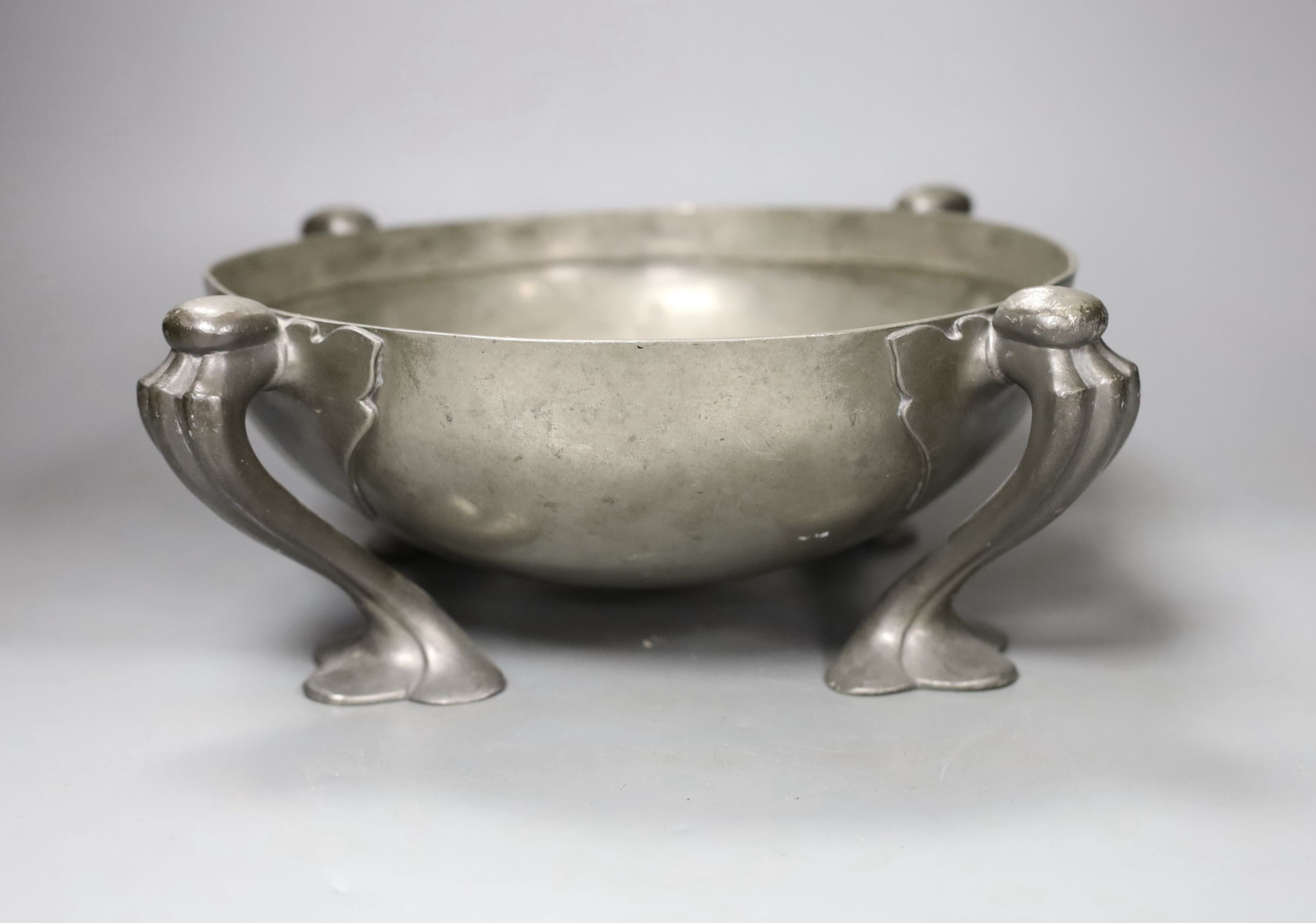 Oliver Baker for Liberty’s, a Tudric pewter fruit bowl, shape 067, on stylised feet, 26cm. diam.